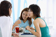 © Alexander - Three young women sitting in cafe, talking
