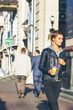 © jon11 - Young girl strolling in casual urban clothes in the city center with a cup of coffee in her hand