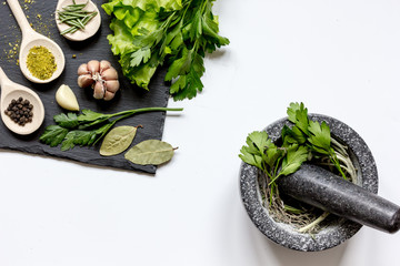 Wall Mural - spices for cooking with pounder on white background top view