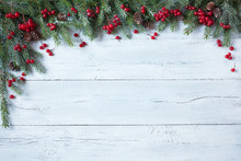 Christmas Wooden Background With Branches Of Trees, Pine Cones And Red Berries