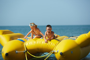 Wall Mural - two happy kids playing on the boat at summer day