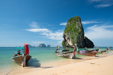 Colorful long tail boats at beautiful Ao Nang beach on a backgro