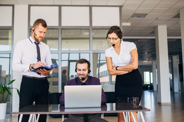 two men and a woman working in the center of the number