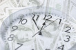 © Syda Productions - clock over money with double exposure