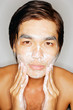 © Alexander - Young man washing face, looking at camera