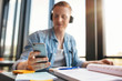 © Jacob Lund - Male student using mobile phone in a library