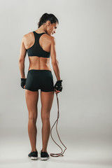 Wall Mural - Fit healthy young athlete with a skipping rope