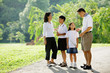 © Alexander - Family standing and talking in park