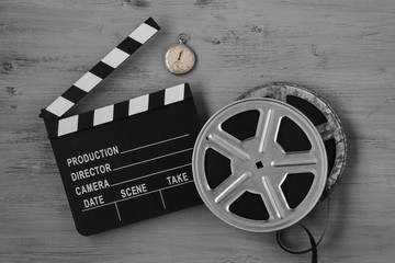 Clapperboards , two film reels and old clock