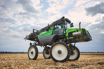 Poster - The tractor works in a field