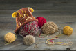 © canonmark2 - balls of yarn and knit cap on a wooden table