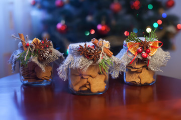 Christmas сookies in a jar on brown table .  Christmas holly. F