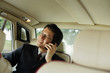 © Alexander - Businessman sitting inside car, using mobile phone