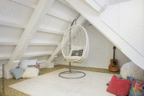 Rattan Hanging Swing Chair Within A Hang Out Area Under Roof