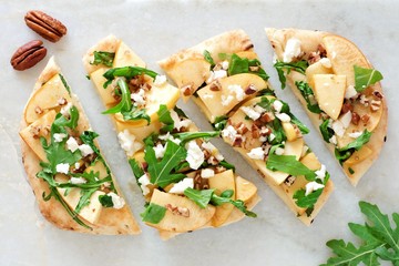 Canvas Print - Flat bread with apples, arugula, feta and pecans, above view on white marble