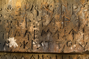 inscription on old tomb in the greek language. characters, symbols. hieroglyphs