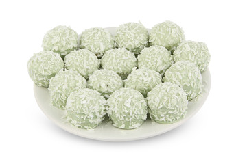 delicious green coconut candies on white plate on  white backgro