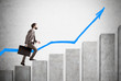 © ImageFlow - Businessman in suit with a case climbing concrete pillars