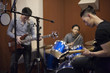 © Blue Jean Images - Musical band in recording studio