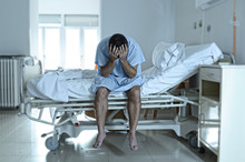 Desperate Man Sitting At Hospital Bed Alone Sad And Devastated S