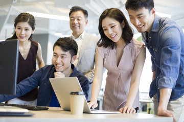 Business people working together with computer and laptop