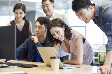 Business people working together with computer and laptop