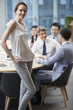 © Blue Jean Images - Portrait of businesswoman with colleagues in background