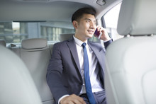 Confident Businessman Talking On Cell Phone Inside Car