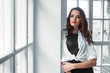 © Sergey Chumakov - young attractive brunette female near window in interior