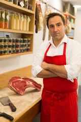 Wall Mural - butcher in apron with arms crossed