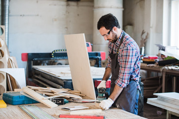 Carpenter with power grinder at his workshop