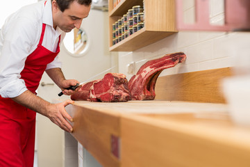 Wall Mural - Butcher Cutting Meat At Counter