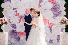 Wedding. Paper Flowers In Wedding Decor. Portrait Of Bride And Groom On Wedding Ceremony With Luxury Wedding Decoration. 
