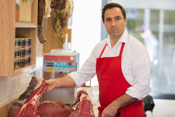 Wall Mural - Butcher Preparing Meat In Shop