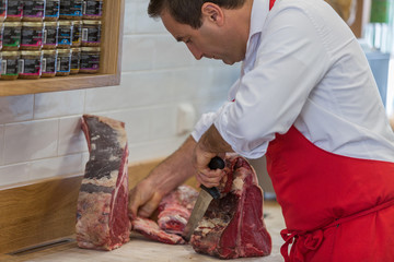 Wall Mural - Butcher Preparing Meat In Shop