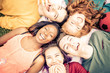 © oneinchpunch - Multi-ethnic group of students studying together outdoors