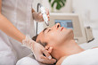 © Yakobchuk Olena - Beautician doing ultrasound cavitation facial massage