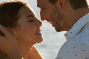 Sticker - Happy couple kissing on sea background