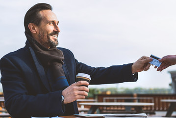 Wall Mural - Businessman giving payment for beverage in cafeteria