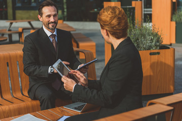 Canvas Print - Business partners discussing project in restaurant