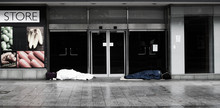 Homeless Sleeping In Closed Shop Door Way