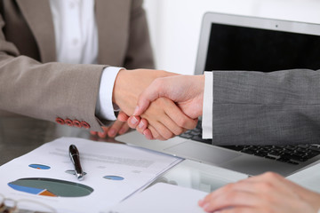 Wall Mural - Business handshake. Two women are shaking hands after meeting or  negotiation.