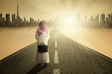 Wall Mural - Arabic entrepreneur standing on road