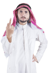 Wall Mural - Arabic person shows middle finger in studio