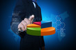 © cutimage - Business man showing pie chart in color background