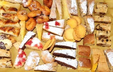 Wall Mural - slices of cake and pastries on sale in the artisan bakery