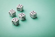 © juliasudnitskaya - White dice on green background. Gambling devices. Copy space for text. All number five. Game of chance concept.