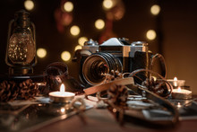Christmas Composition Old Vintage Camera, Candles, Flashlight On A Dark Wooden Table