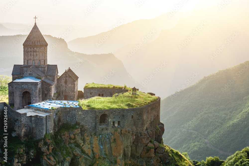 Ancient monastery in setting sun. Tatev. Armenia - obrazy, fototapety, plakaty 
