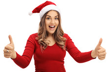 Joyful Woman Wearing A Christmas Hat Giving Two Thumbs Up
